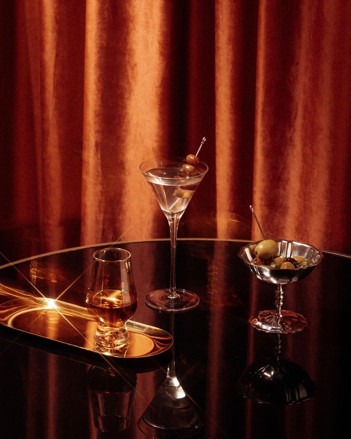 Cocktail glasses on a dimly lit bar, hospitality branding by BHA Future Co